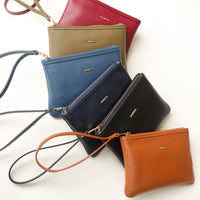 Collection of leather wristlets in various colors on a white background