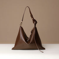 Interior view of Zesté Crossbody Lux – microsuede-lined leather bag with gold hardware and matching zip pouch by Danilo’s