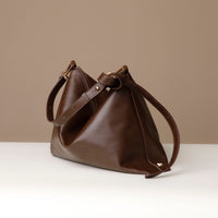 Brown Zesté Crossbody Lux bag with adjustable strap – worn as shoulder, crossbody, or top-handle handbag for versatile styling