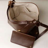 Interior view of Zesté Crossbody Lux – leather bag with gold hardware and matching zip pouch by Danilo’s