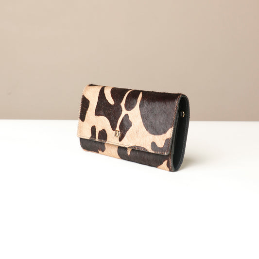 patterned fur clutch Danilos bag on a beige background