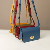 Set of colorful handbags with matching straps on a neutral background