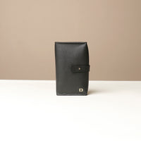 Front view of a black Danilos Pebble executive accessory holder linea on a beige background