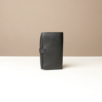 Back view of a black Danilos Pebble executive accessory holder linea on a beige background