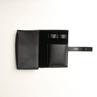 Open view of a black Danilos Pebble executive accessory holder linea on a beige background