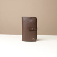 Front view of a brown Danilos Pebble executive accessory holder linea on a beige background