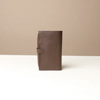 Back view of a brown Danilos Pebble executive accessory holder linea on a beige background