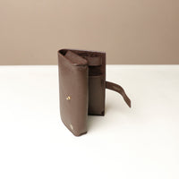 Side view slightly open brown Danilos Pebble executive accessory holder linea on a beige background