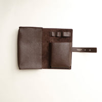 Open view of a brown Danilos Pebble executive accessory holder linea on a beige background