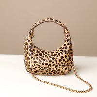 hair on leather Leopard print danilos  handbag with a gold chain on a beige background