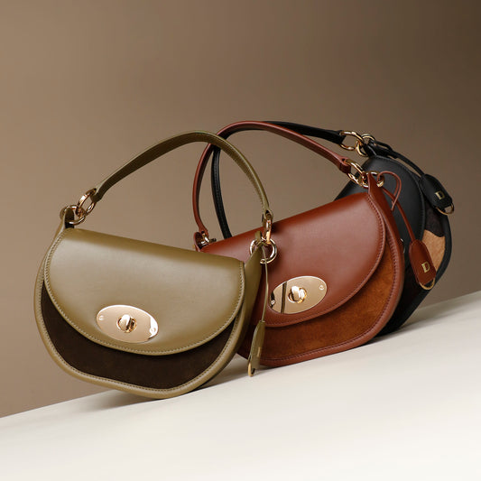 Three leather Danilos handbags in different colors on a neutral background