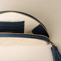 close-up of a Agnes satchel raffia lavanda with navy details craft with leather, and a gold hardware