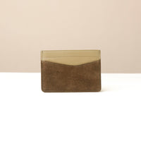 green suede leather Danilos cardholder with beige top and brown bottom on a white background