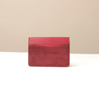 Red suede leather Danilos cardholder on a beige background