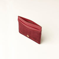 Red suede leather cardholder with gold Danilos logo on a white background