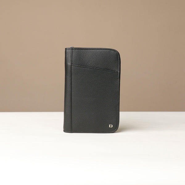 Front view of a black Danilos Pebble leather Document Portfolio Alfaro on a beige background