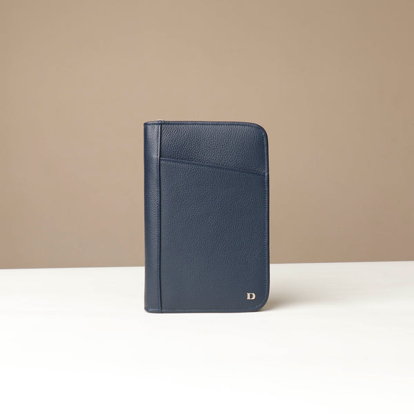 Front view of a blue Danilos Pebble leather Document Portfolio Alfaro on a beige background