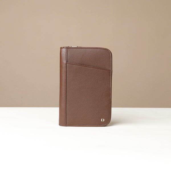 Front view of a Brown Danilos Pebble leather Document Portfolio Alfaro on a beige background