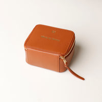 back view of a small leather Danilos Jewelry Organizer Anushka in brown with embossed gold text on a white background
