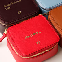 close-up view of a small leather Danilos Jewelry Organizer Anushka in red with embossed gold text on a white background