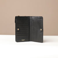 front view of a open black danilos leather multi smartphone alessia with 19 slots over a beige background