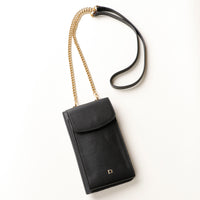 front view of a black danilos leather multi smartphone alessia with a gold zipper pocket and chain with leather combination over a beige background