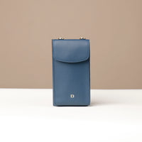 front view of a blue danilos leather multi smartphone alessia over a beige background