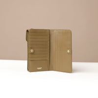 front view of a open green danilos leather multi smartphone alessia with 19 slots over a beige background