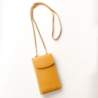 front view of a yellow danilos leather multi smartphone alessia with a gold zipper pocket and chain with leather combination over a beige background