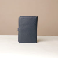 Back view of a marine blue Danilos pebble leather inkspirator on a beige background