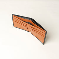 upper view of a black pebble leather Milano wallet with a orange inside, eight card slots and two money slots