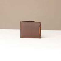 Front of a brown pebble leather Milano wallet with a orange card case holder slot that comes out of one of the sides