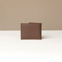 Back view of a brown pebble leather Milano wallet over a beige background