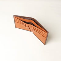 upper view of a brown pebble leather Milano wallet with a orange card case inside, 8 card slots and 2 money slots