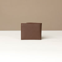 Back view of a brown pebble leather Milano wallet over a beige background