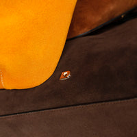 Close-up of a brown suede leather surface with a small Danilos logo.