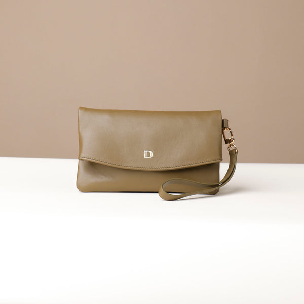 Front view of a olive green leather Karelia Clutch Danilos with a visible hand strap over a white and beige background