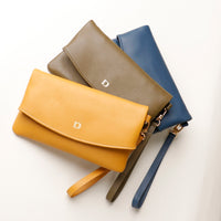 three yellow, green leather and blue clutch karelia with the danilos brand logo in silver over a white background