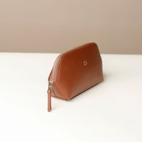Brown leather pouch with a gold zipper on a white surface