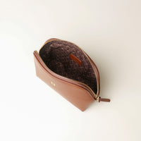 Brown leather pouch open with zipper on a white background