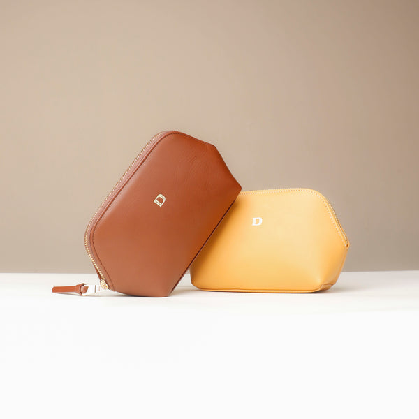 Brown and yellow hexagonal pouches on a beige background