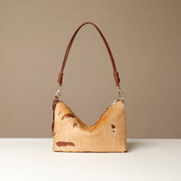 crossbody Danilos bag made of animal skin with a brown handle on a beige background