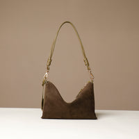 green suede Danilos handbag with a strap on a beige background