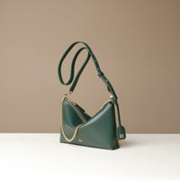 Green Danilos handbag with gold chain detail on a beige background
