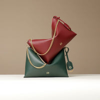 Two leather Danilos handbags, one green and one red, with gold chains on a beige background.