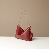 Red Danilos handbag with a gold chain on a beige background