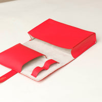 close up view of a open unused red Danilos Pebble executive accessory holder linea on a beige background