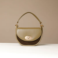 Green Daniloshandbag with a gold clasp on a beige background