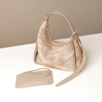 Beige Danilos handbag and pouch on a white surface with a beige background