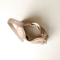 Beige hair on leather Danilos handbag opened upper view with a strap on a white background